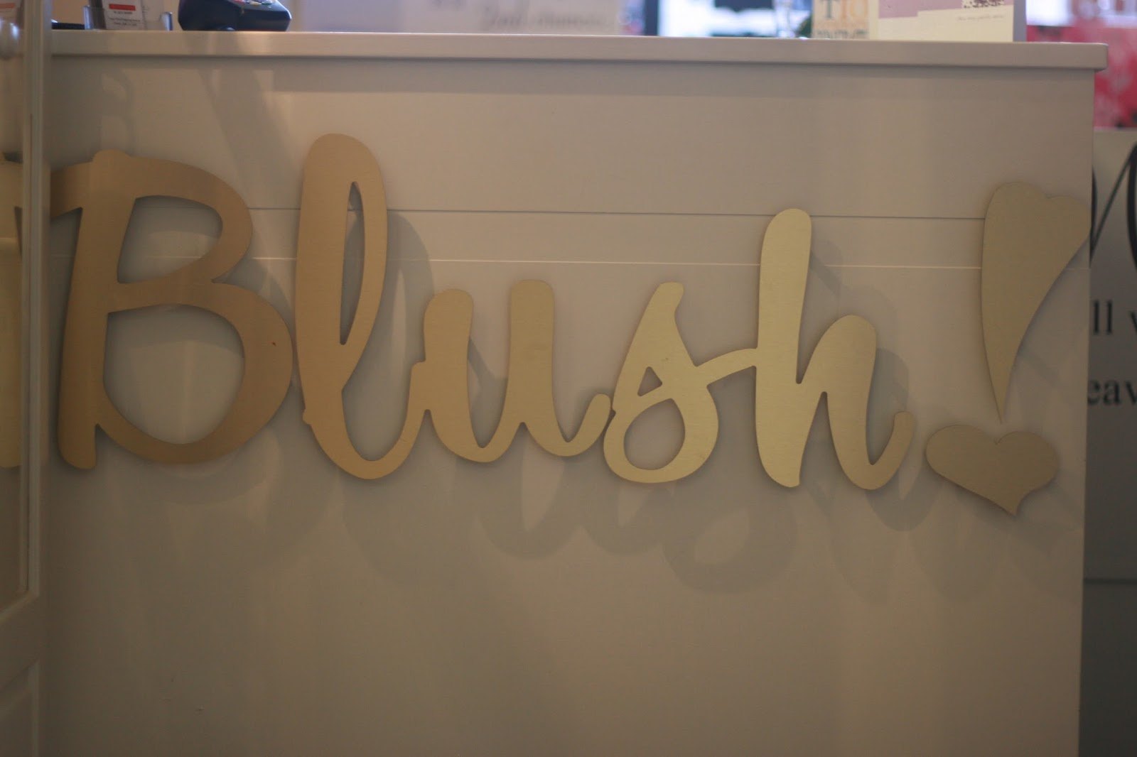 Gold Blush! lettering on the white reception desk inside Blush Beauty Salon, Cobh